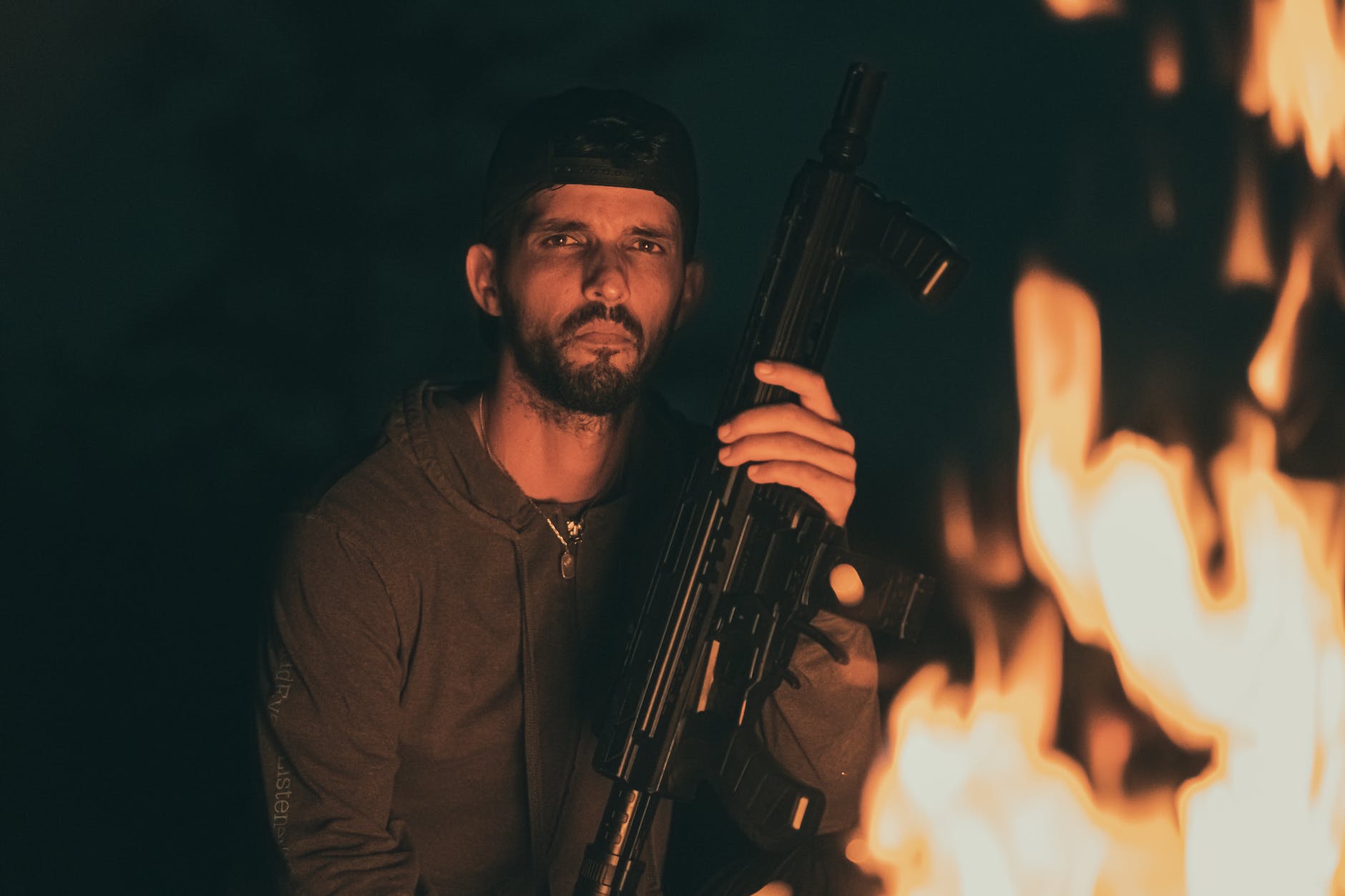 man sitting with automatic gun