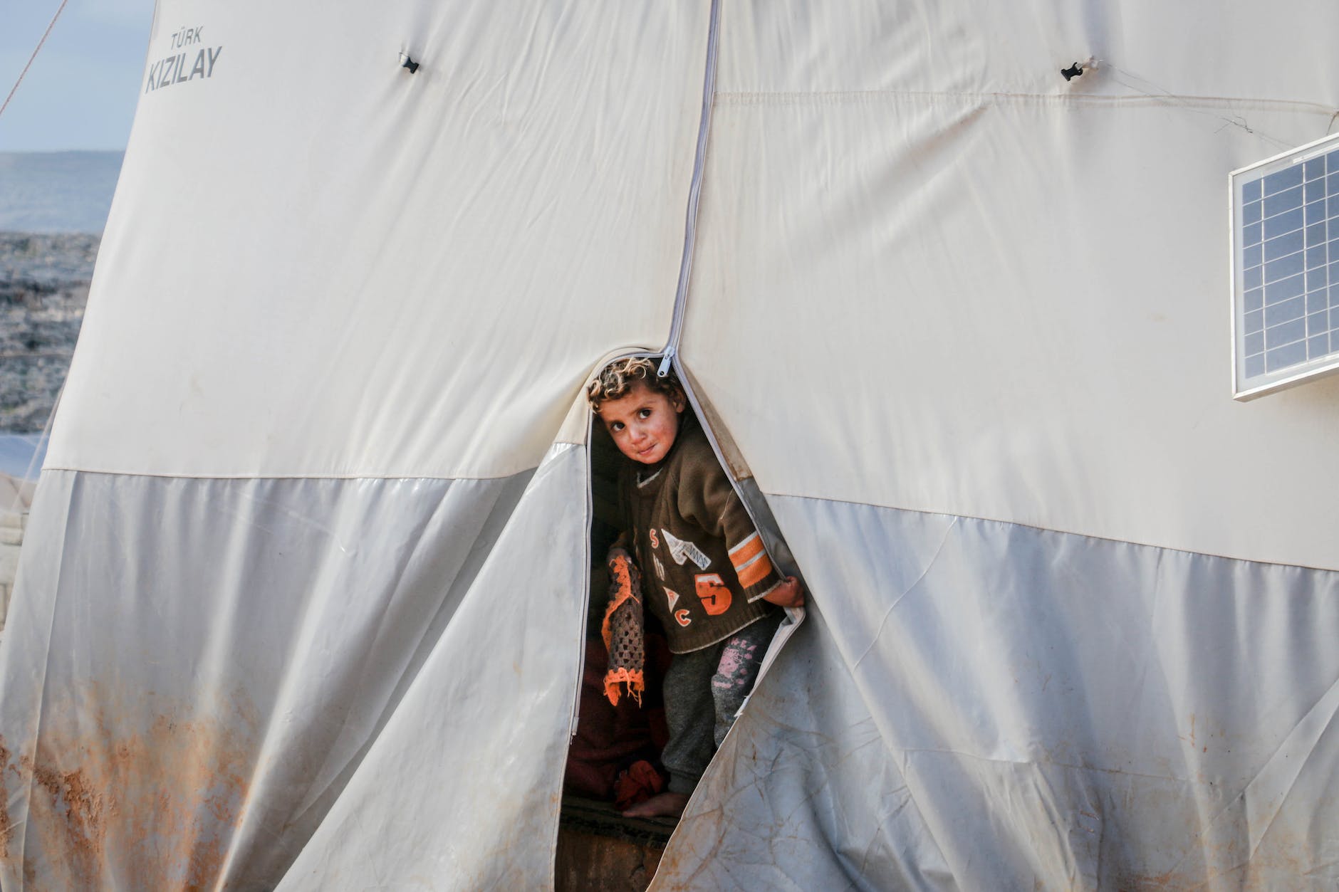 poor ethnic boy in dirty tent