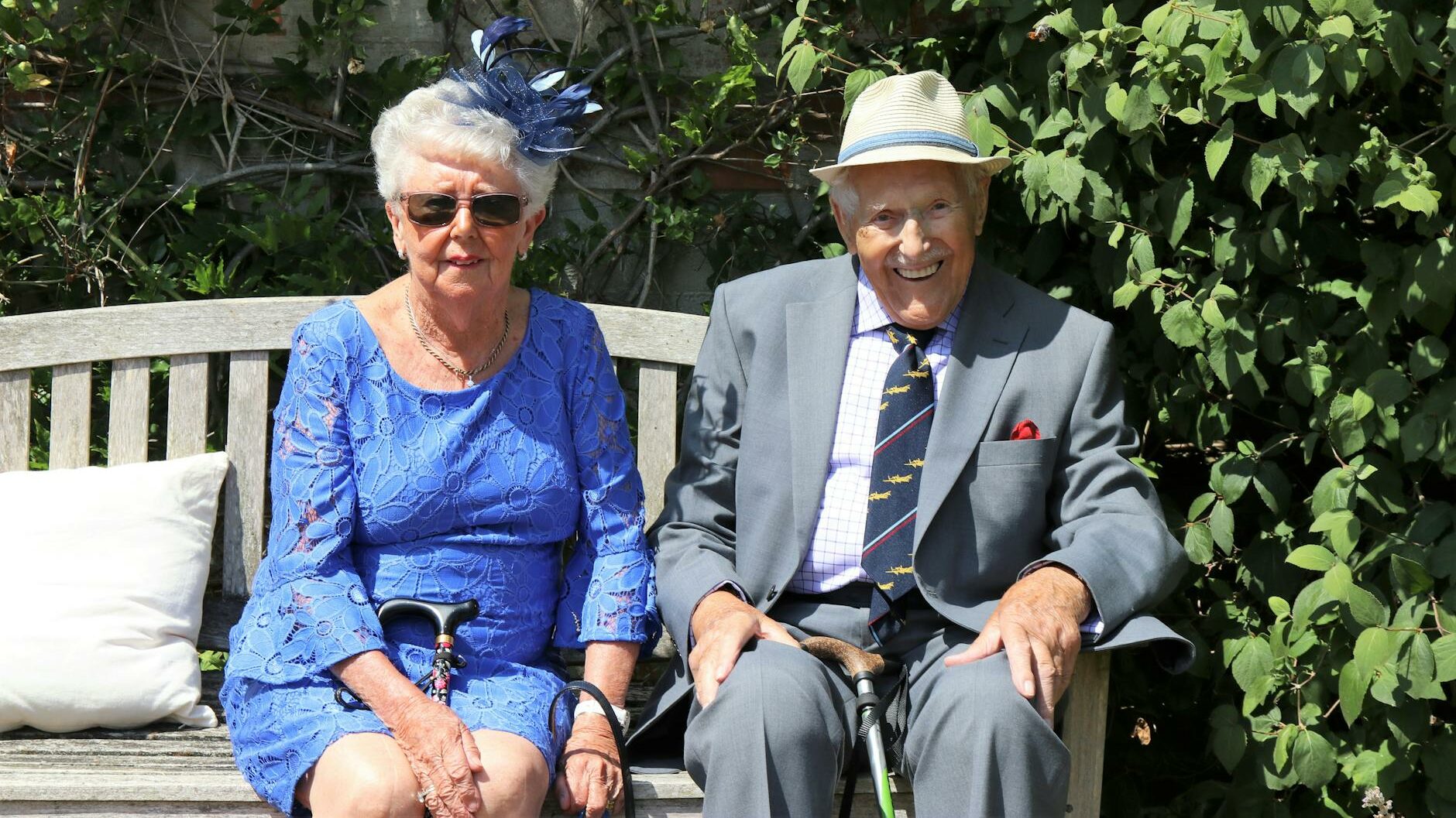 woman sitting beside man on wooden bench