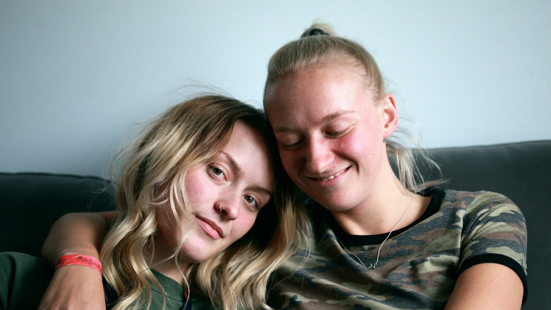 women sitting on couch